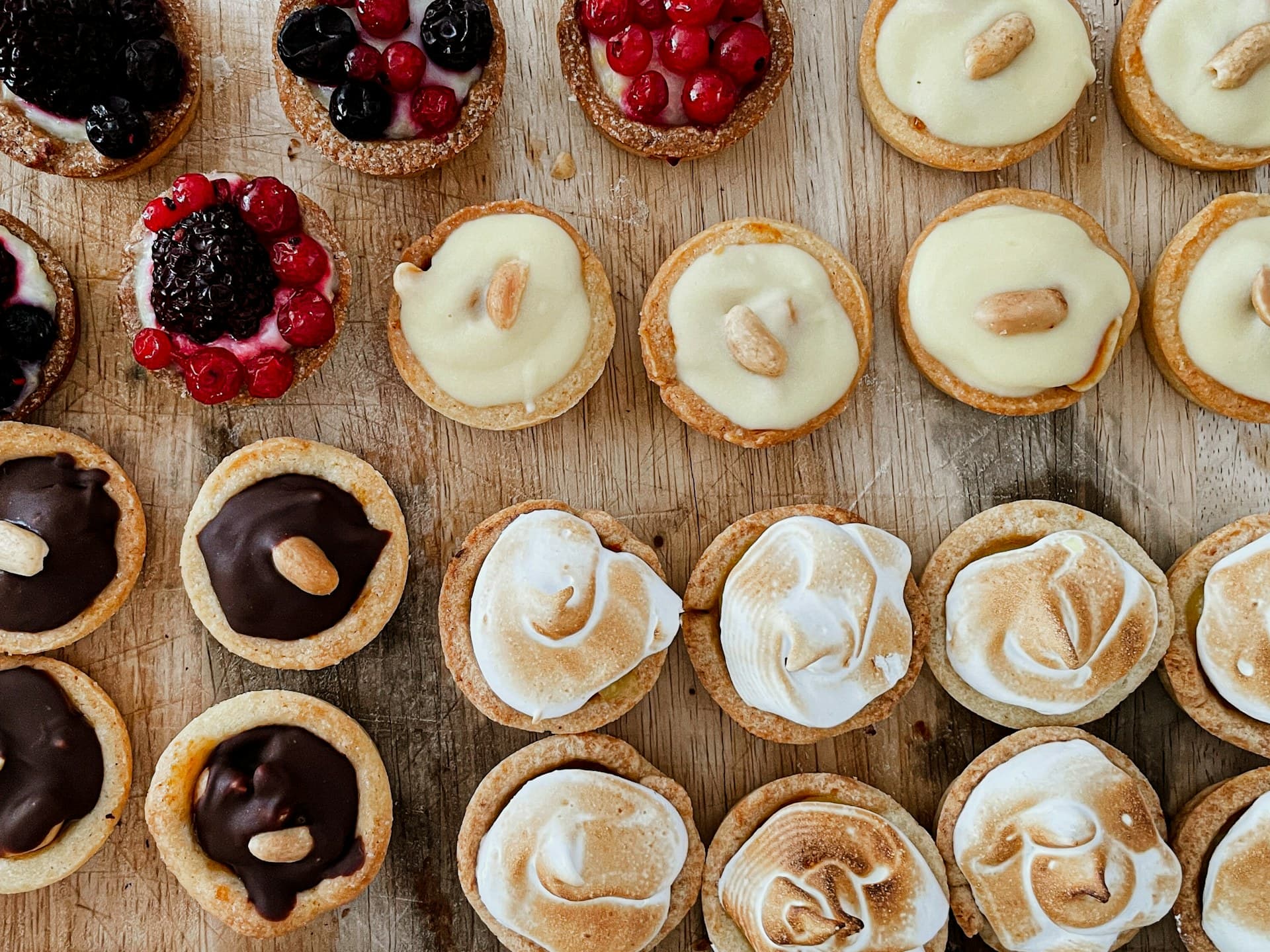 A wooden board of assorted tartlets, fresh from the oven